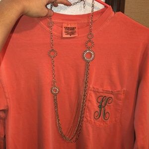 Long silver necklace with multiple bottom chains